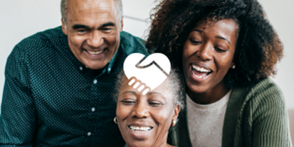 two older adults with young adult looking at mobile device 